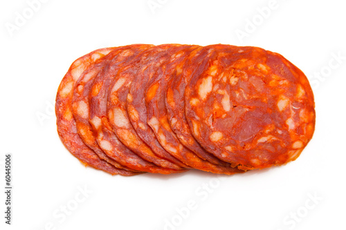 Sliced chorizo sausage isolated on a white studio background. photo