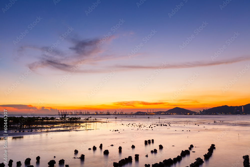 Sunset over sandy beach in low tide Sunset over sandy beach in low tide