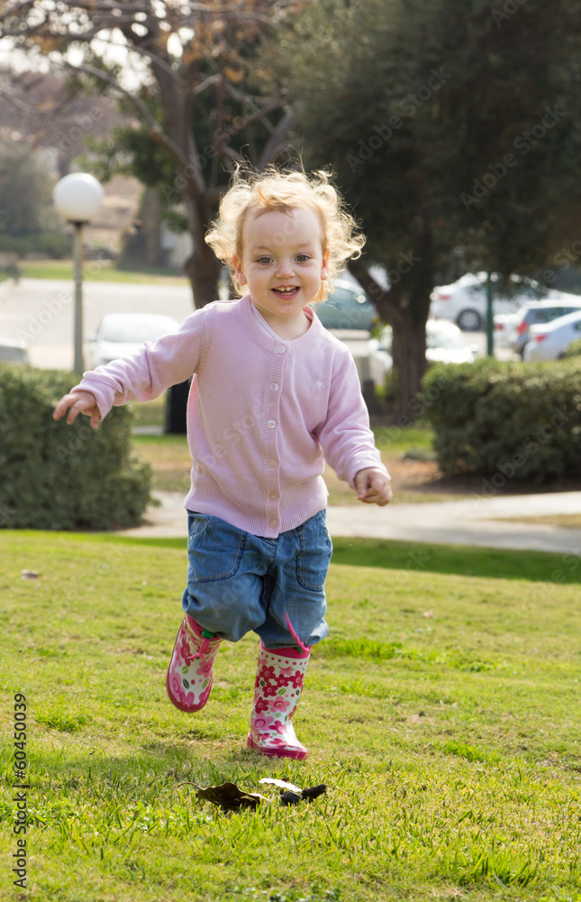 Adorable little girl playing in autumn park Adorable little girl playing in autumn park