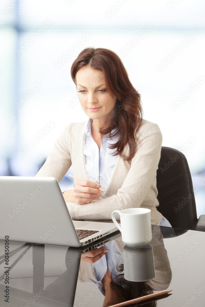 Beautiful businesswoman working on her laptop