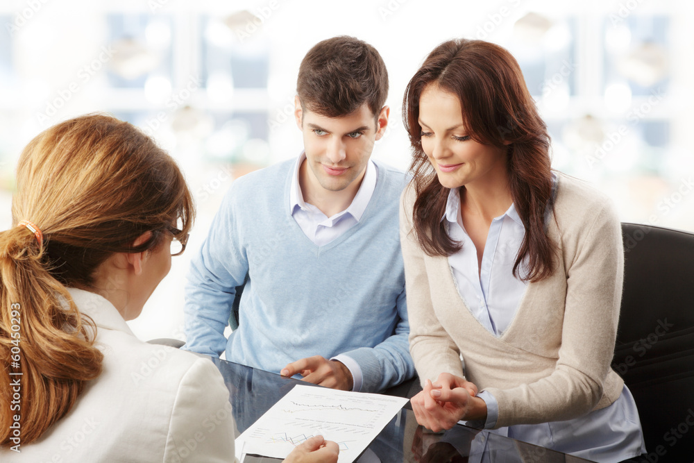 Young couple discussing financial plan with consultat Young couple discussing financial plan with consultat