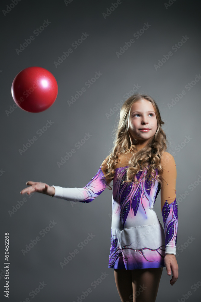 Beautiful artistic gymnast throws ball in studio Beautiful artistic gymnast throws ball in studio