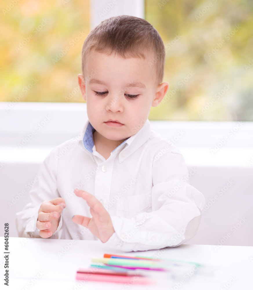 Little boy is drawing on white paper Little boy is drawing on white paper