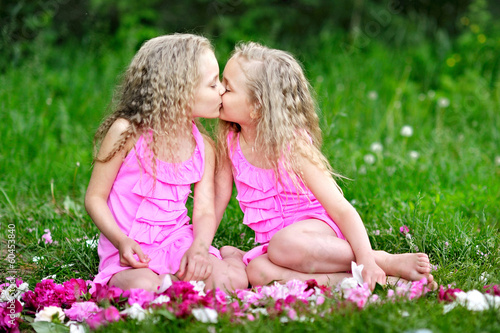 Obraz na plátne portrait of two twins with peonies