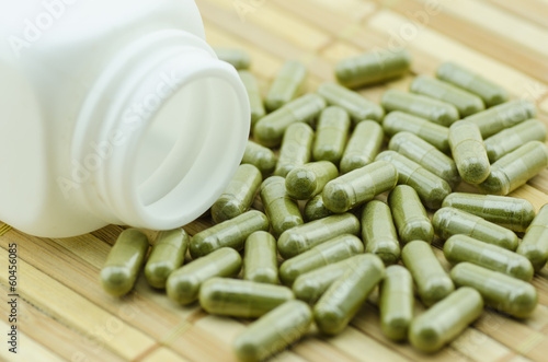 moringa capsule pills with medicine bottles