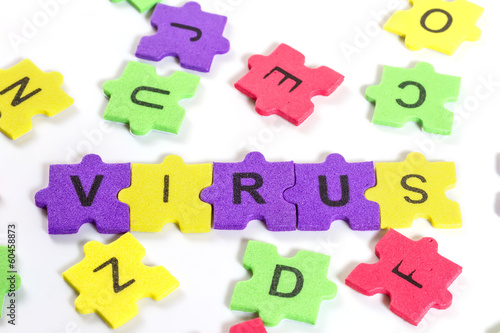 word VIRUS formed with colorful foam puzzle on white background
