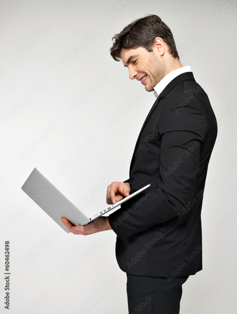 Portrait of young man with laptop in casuals Portrait of young man with laptop in casuals