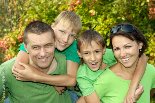 cheerful family in green shirts