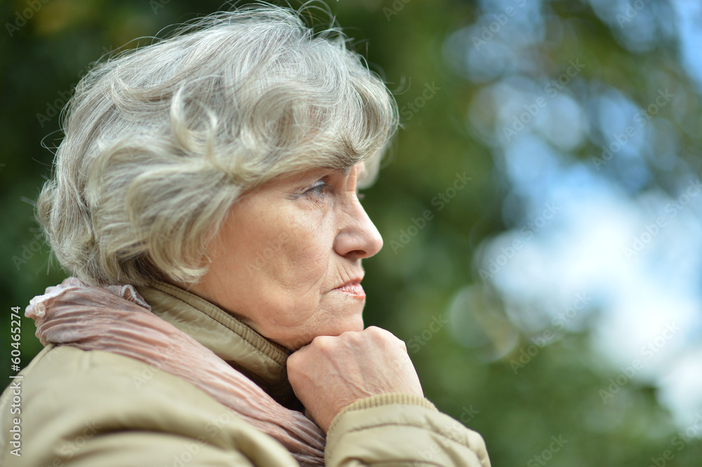 Thoughtful senior woman in autumn Thoughtful senior woman in autumn