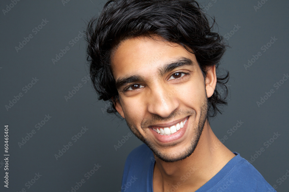 Close up portrait of a cheerful young man smiling Close up portrait of a cheerful young man smiling