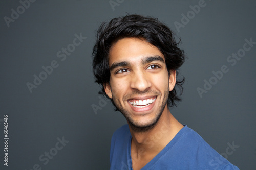Close up portrait of a happy young man smiling © mimagephotos