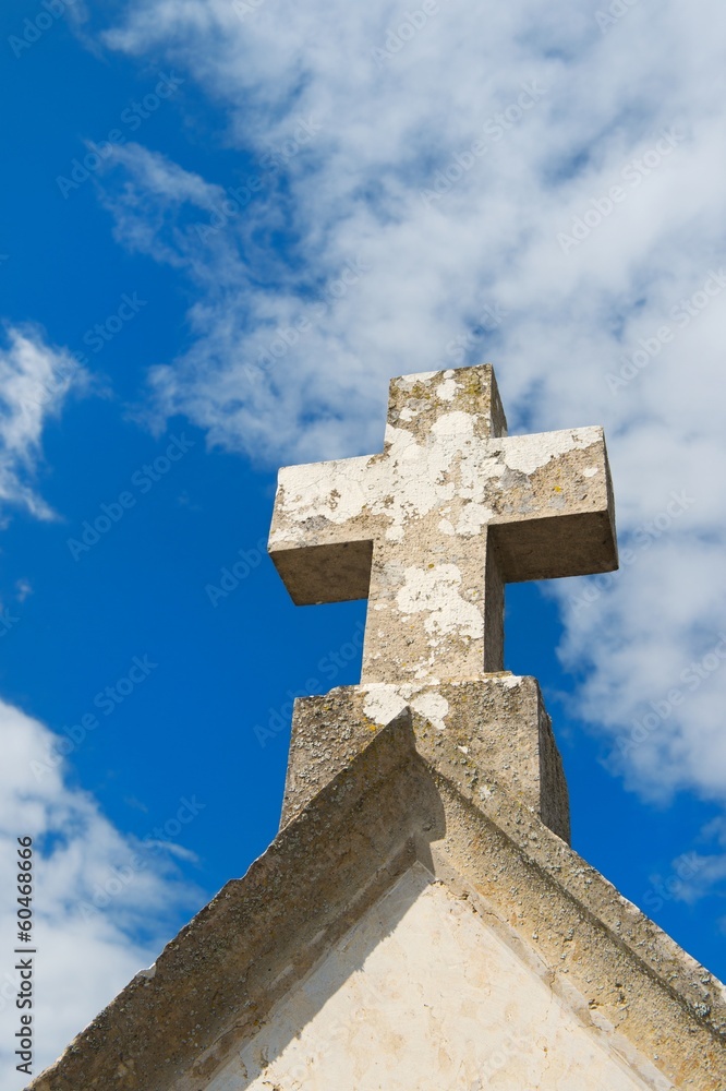 Stone cross on old church