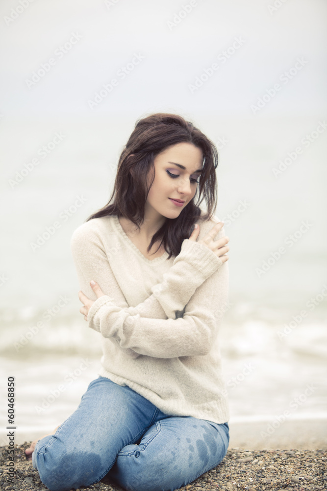 romantic girl sitting on the beach