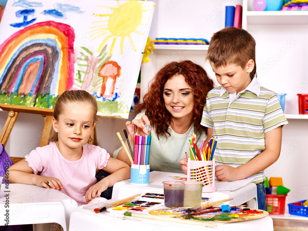 Fototapeta premium Child painting at easel.