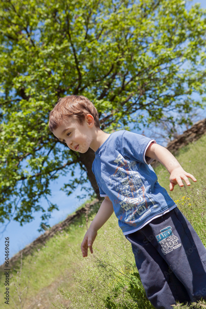 Boy enjoys happiness in the summer sun. Boy enjoys happiness in the summer sun.