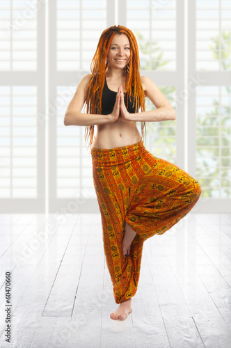 Beautiful young girl in yoga pose. photo