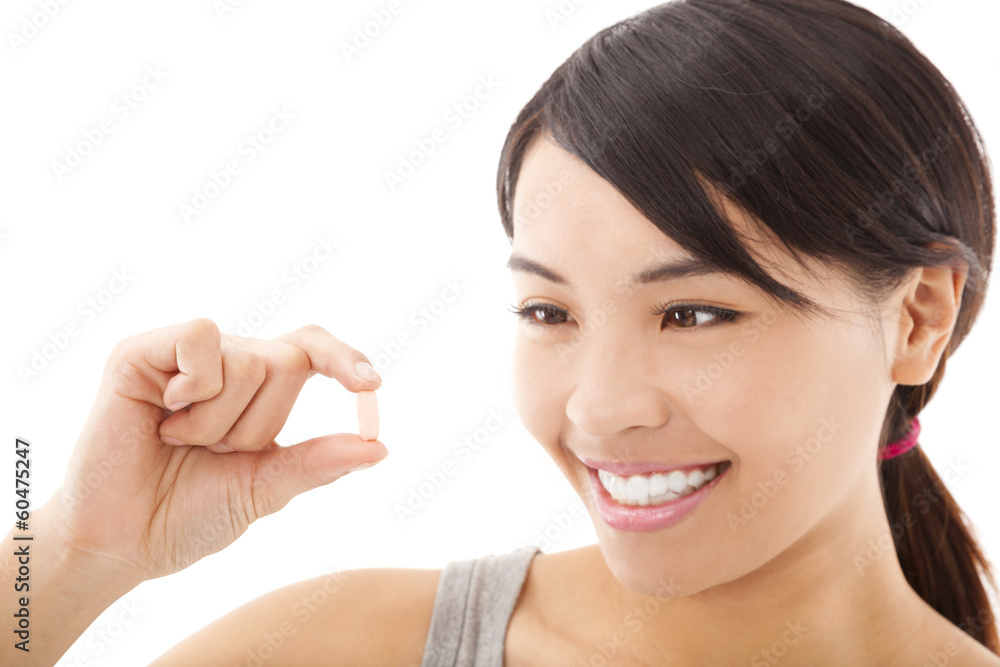 Portrait of young happy smiling woman showing vitamin Portrait of young happy smiling woman showing vitamin