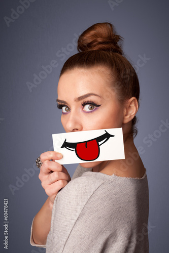 Happy pretty woman holding card with funny smiley