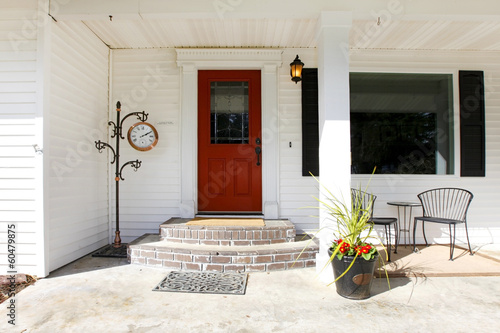 White classic porch with a red wooden door