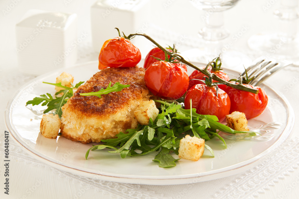 Chicken cutlet with grilled tomatoes and salad. Chicken cutlet with grilled tomatoes and salad.