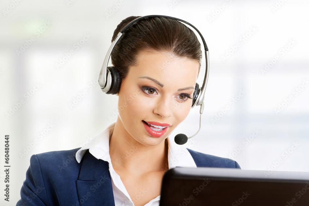 Beautiful young call-center assistant smiling Beautiful young call-center assistant smiling