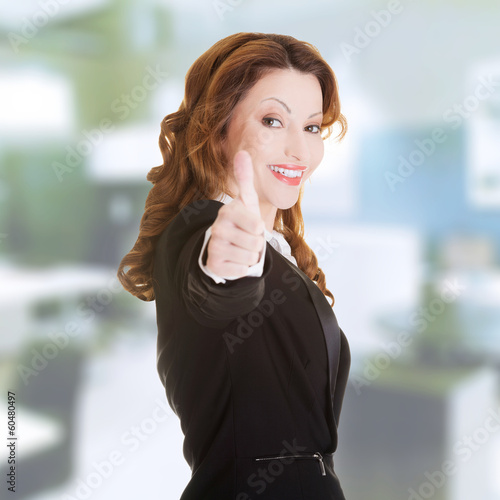 Business woman with thumbs up, ok gesture