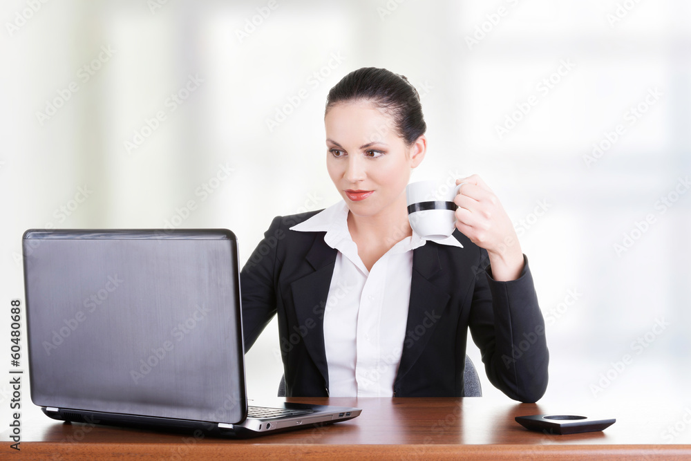 Beautiful brunette businesswoman working on laptop Beautiful brunette businesswoman working on laptop