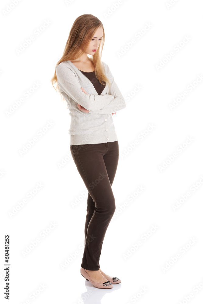 Beautiful woman is standing, lookis sad, with her hands crossed. Beautiful woman is standing, lookis sad, with her hands crossed.