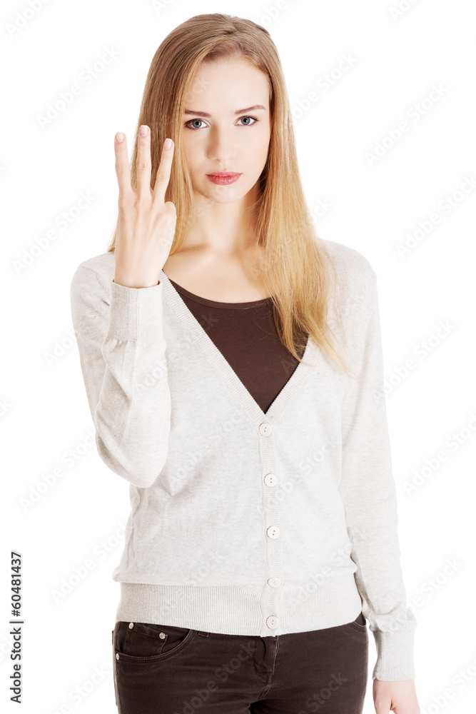 Beautiful casual woman showing three fingers. Beautiful casual woman showing three fingers.