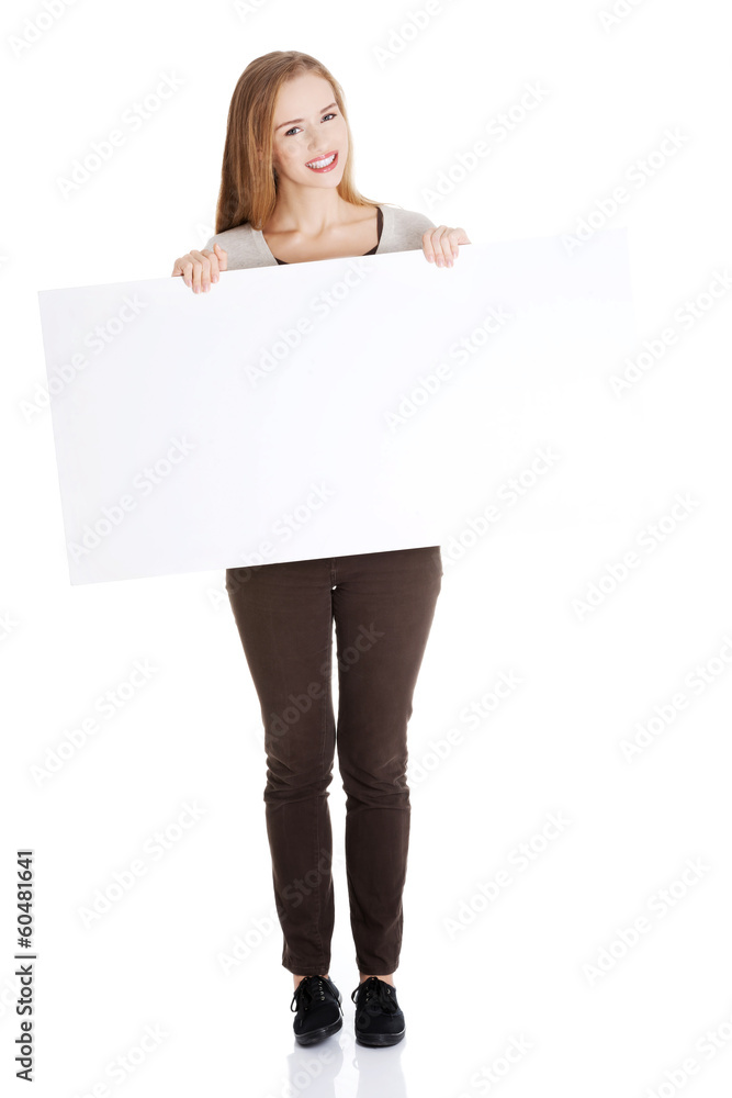 Beautiful casual woman holding copy space and advertising. Beautiful casual woman holding copy space and advertising.