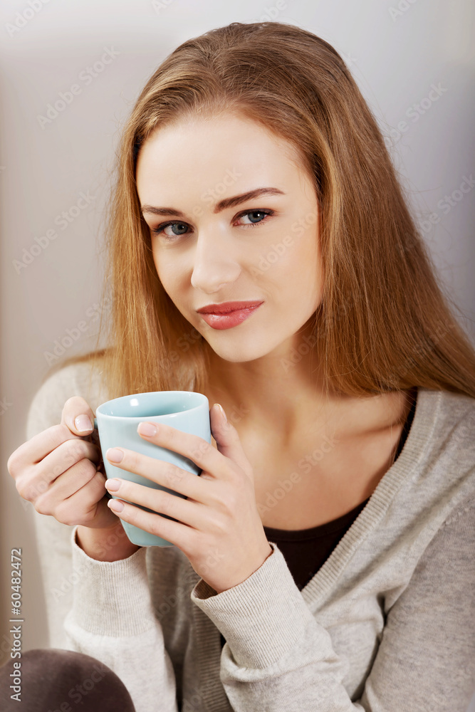 Beautiful casual caucasian woman sitting with hot drink. Beautiful casual caucasian woman sitting with hot drink.
