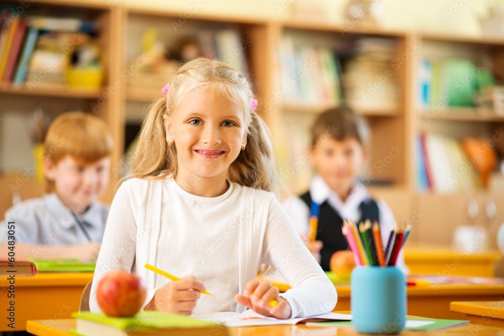 Fototapeta premium Children behind school desks during lesson