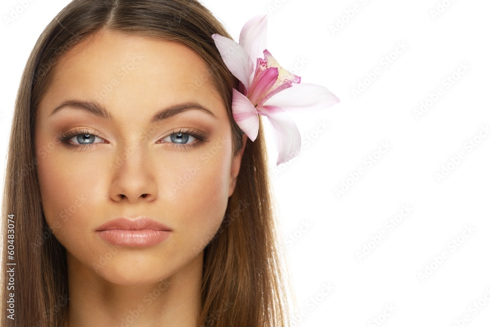 Young beautiful brunette woman with orchid flower
