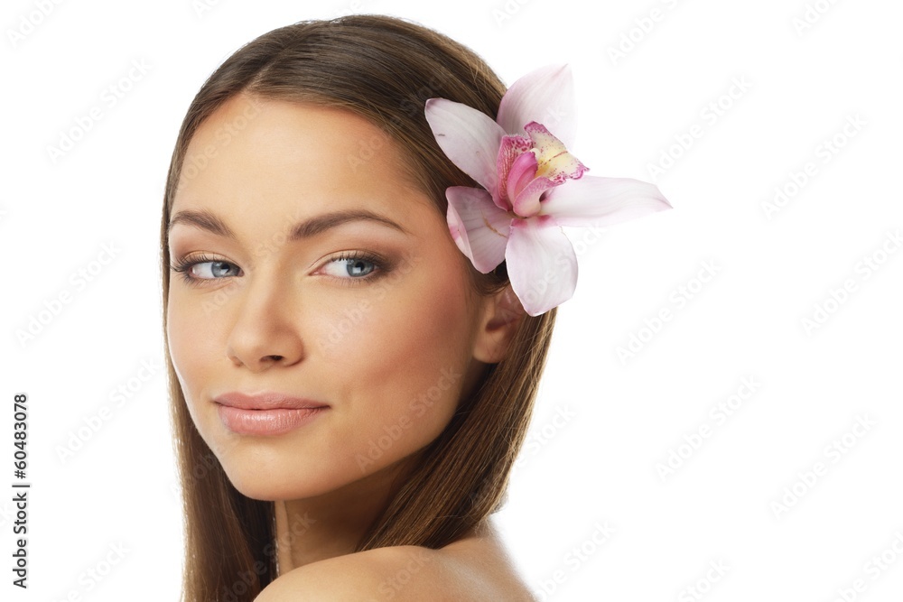 Fototapeta premium Young beautiful brunette woman with orchid flower