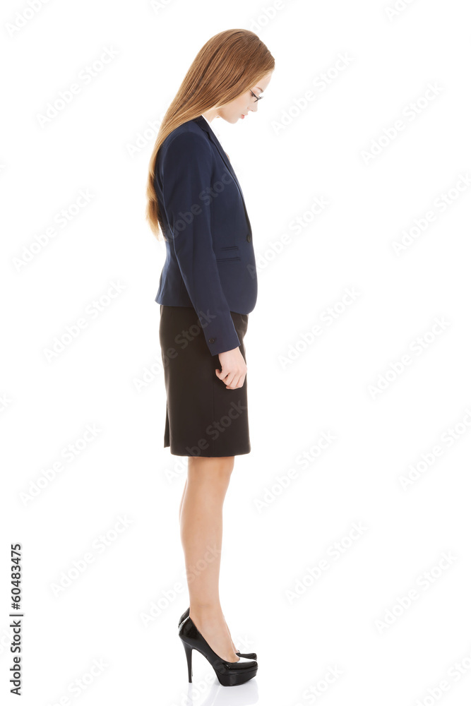 Beautiful business woman looking down. Side view. Beautiful business woman looking down. Side view.