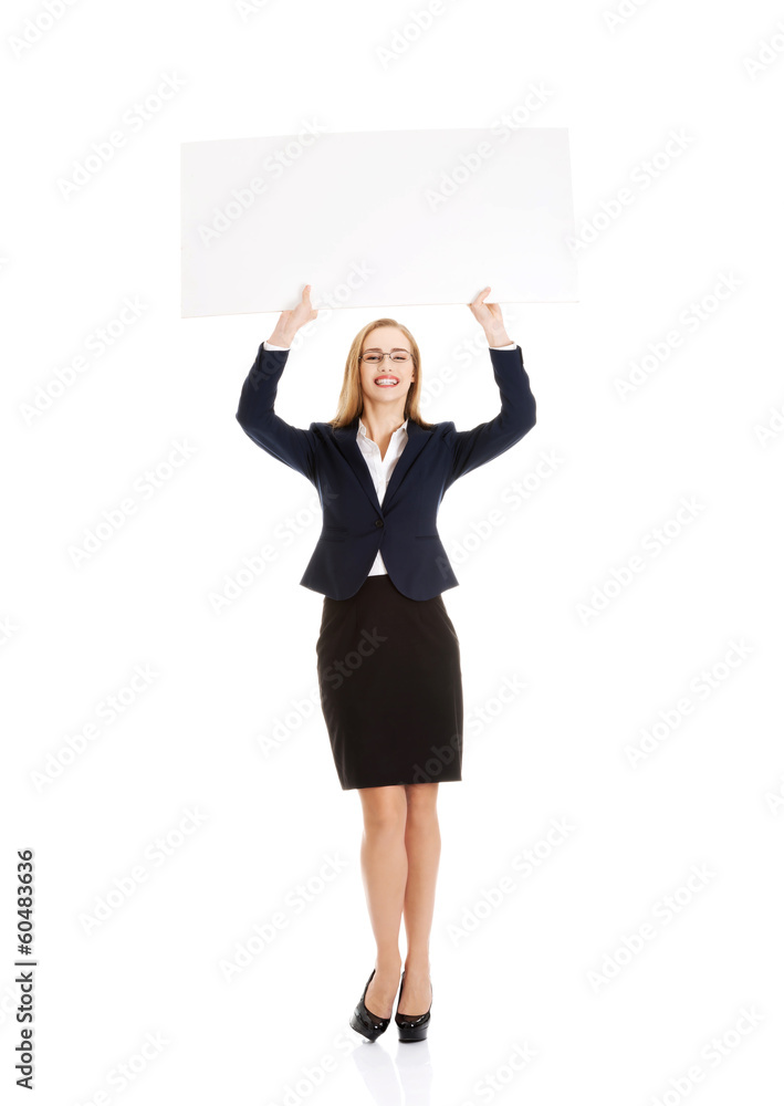 Beautiful young business woman holding copy space. Beautiful young business woman holding copy space.