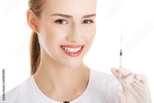 Beautiful young nurse with needle.