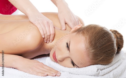 Beautiful caucasian woman lying on the massage table and is bein