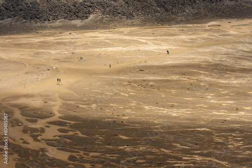 people walking accros barren land at Tongariro National Park