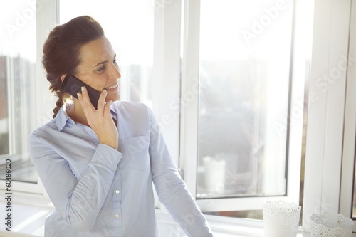 Attractive female executive talking on her mobile phone