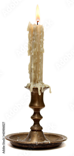 burning old candle vintage bronze candlestick.