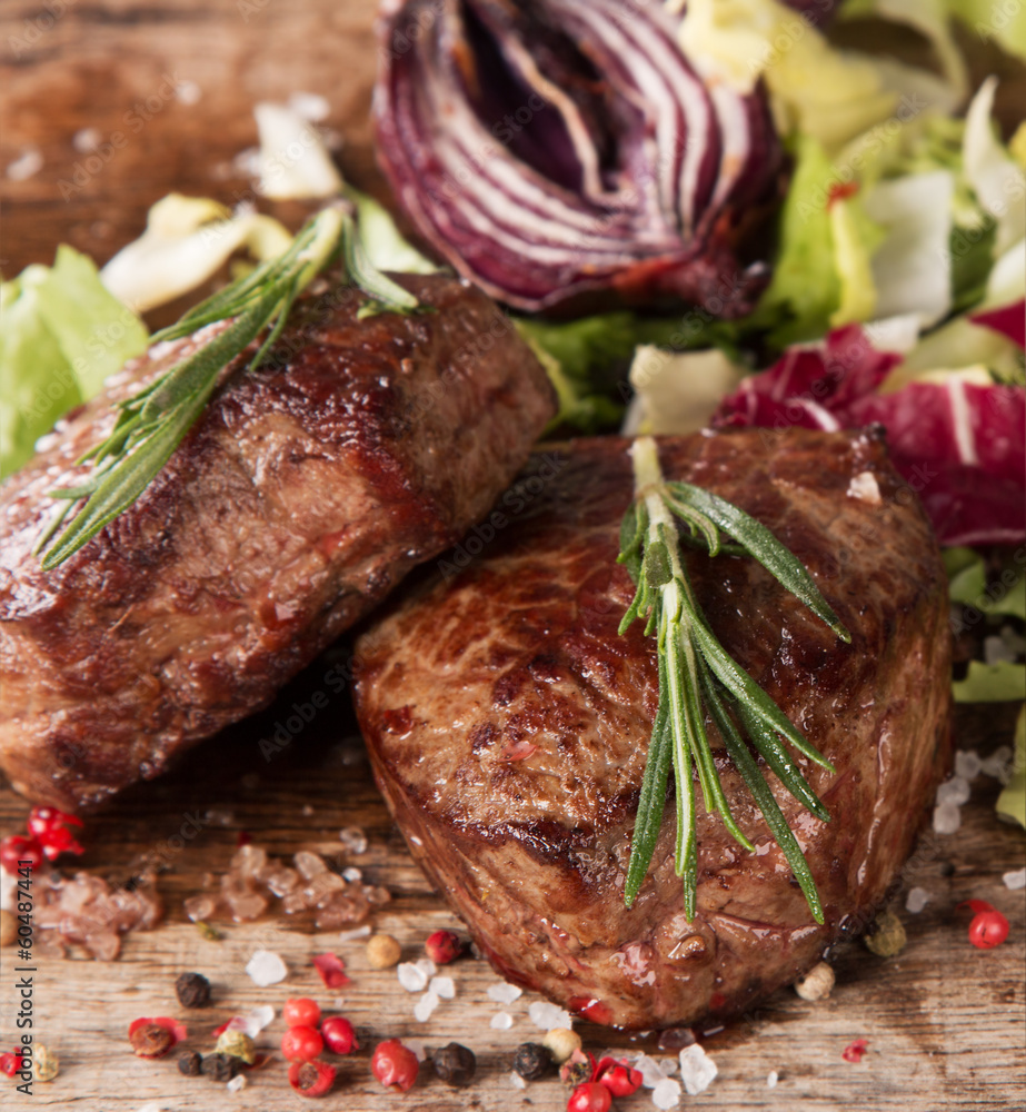 Grilled steaks on wood Grilled steaks on wood