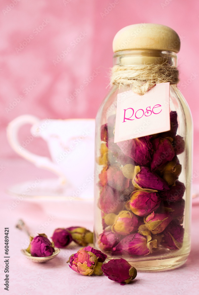 Dried rosebuds tea in a glass bottle Dried rosebuds tea in a glass bottle