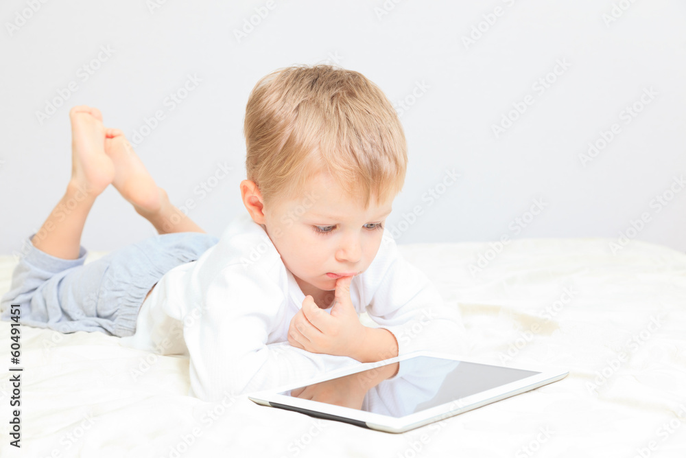 little boy with touch pad, early learning