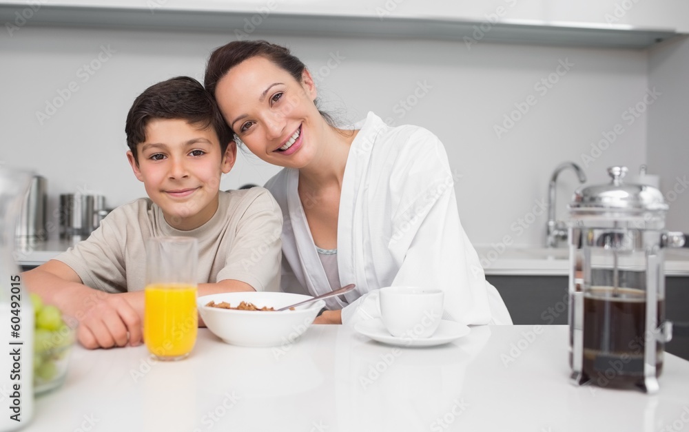 Portrait of a smiling mother with son in kitchen Portrait of a smiling mother with son in kitchen