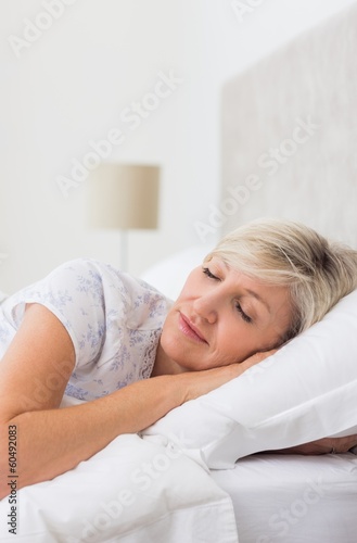 Mature woman sleeping with eyes closed in bed