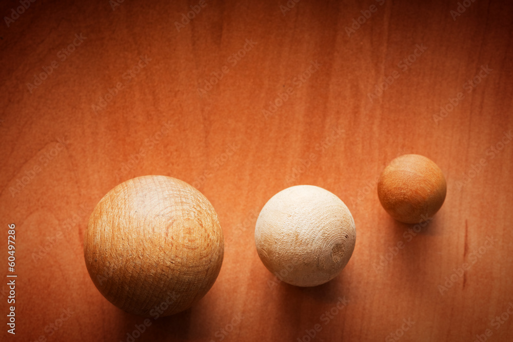 Three wooden balls on a wooden board. Three wooden balls on a wooden board.