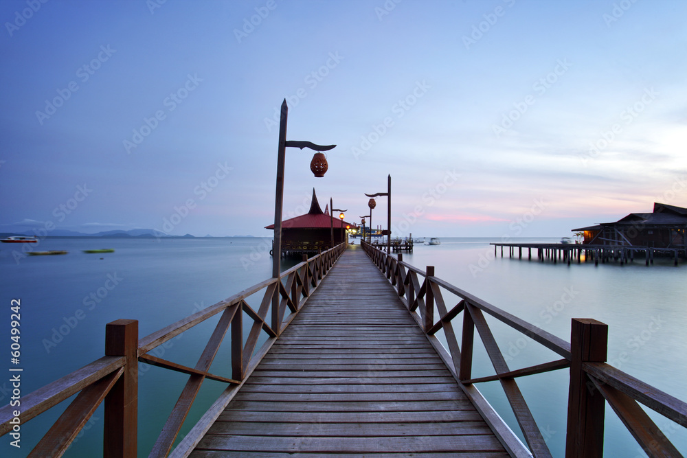 wooden jetty on mabul island looking across the ocean to sipadan