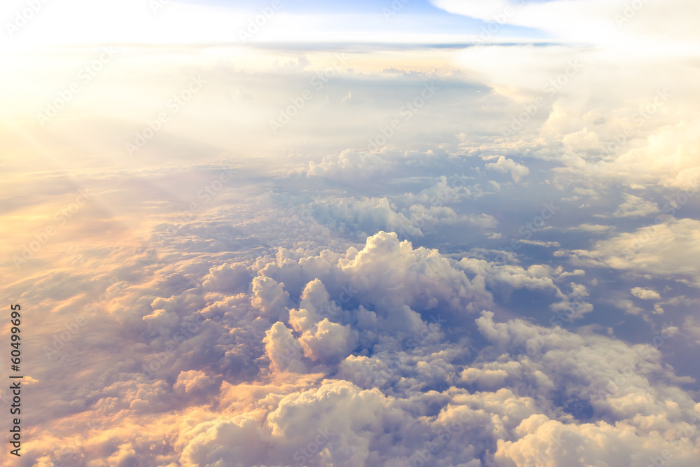 Fototapeta premium Clouds and sky as seen through window of an aircraft