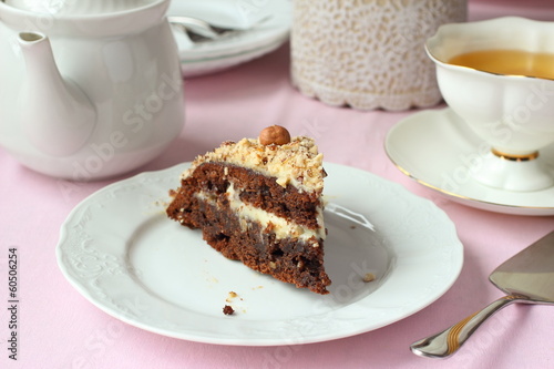 Piece of Chocolate cake with nuts and tea